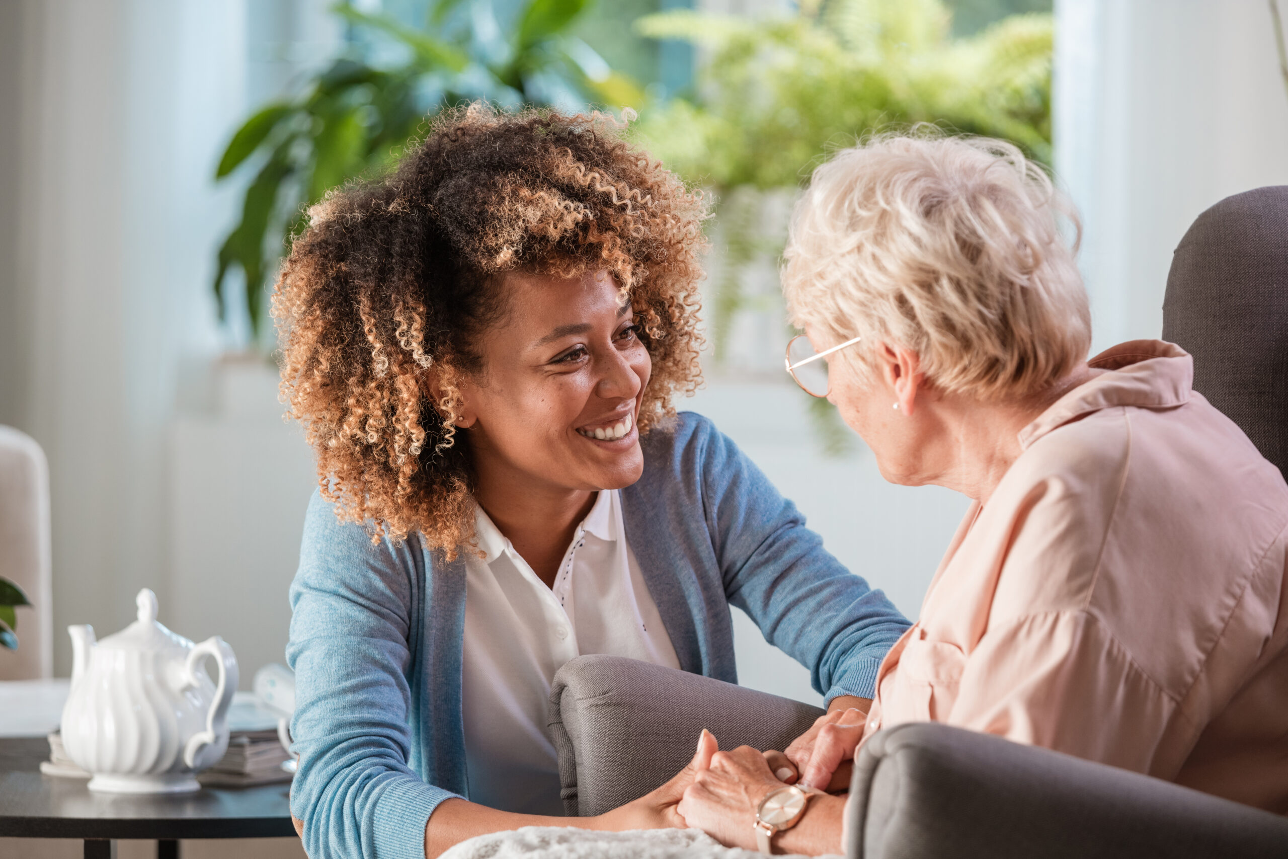 Caregiver helping elderly woman