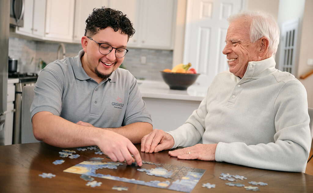 Caregiver doing a puzzle with a senior