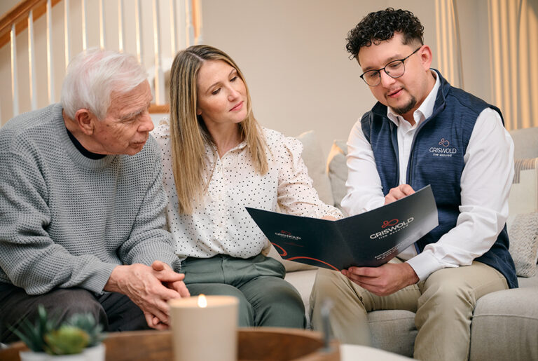 Care team member showing daughter of senior father documents