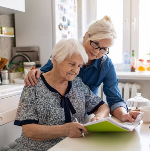 Woman helping Elderly Woman