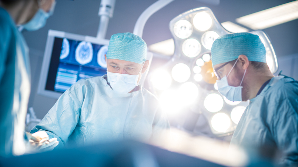 Surgeons in a well-lit operating room