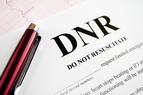 A "Do Not Resuscitate" form lies on a table