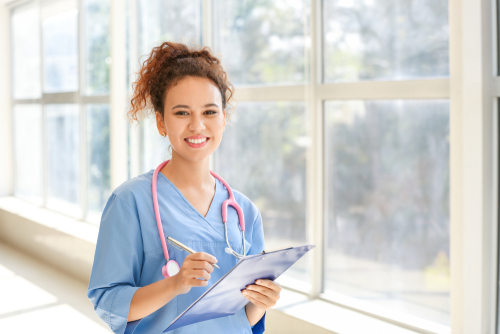 A healthcare professional in blue scrubs