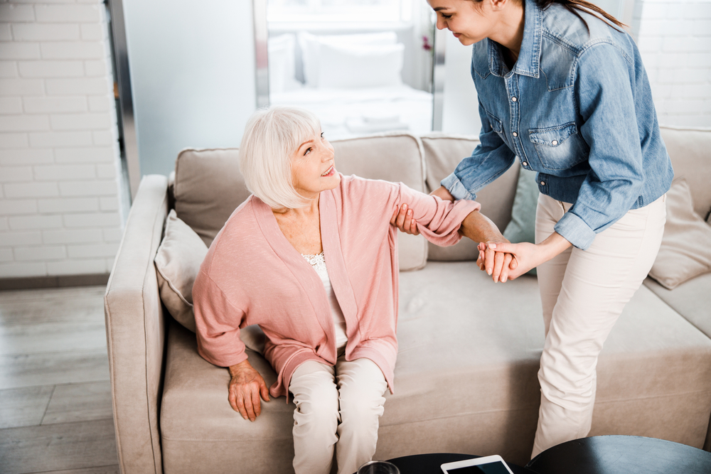 An older woman assisted by a younger woman