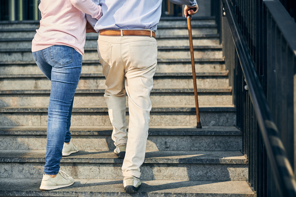 A person walking up a set of outdoor stairs