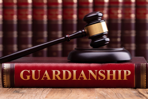 A gavel rests on a book titled "Guardianship,"