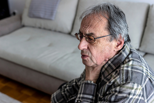 Elderly man sitting on a couch