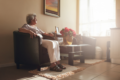 An elderly woman sitting in an arm chair