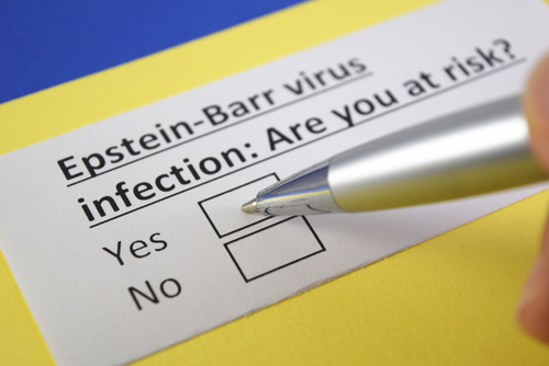 A hand holding a pen hovers over a checkbox on a form that reads, "Epstein-Barr virus infection: Are you at risk?" with options "Yes" and "No,"