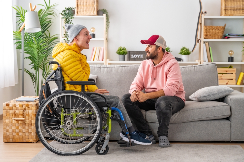 Two men are indoors, conversing