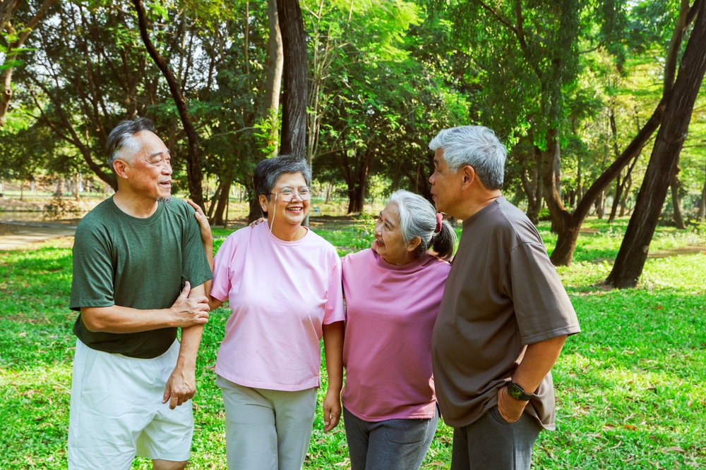 Four older adults walking together