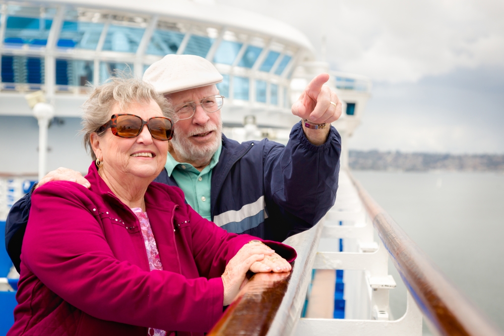 An elderly couple enjoys a boat trip