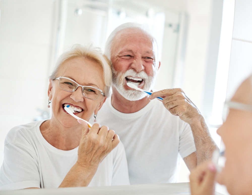 This heartwarming scene highlights the importance of elder home care services in maintaining daily routines and personal hygiene.