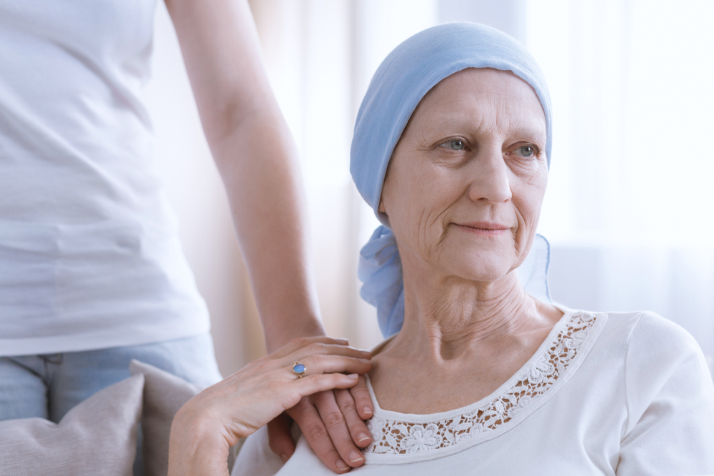 An elderly woman wearing a blue headscarf