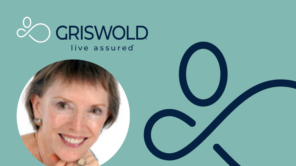 A woman smiling, with short hair and a finger touching her chin. The Griswold Home Care logo and their slogan "live assured" are displayed against a teal background, promoting their exceptional caregiver services.