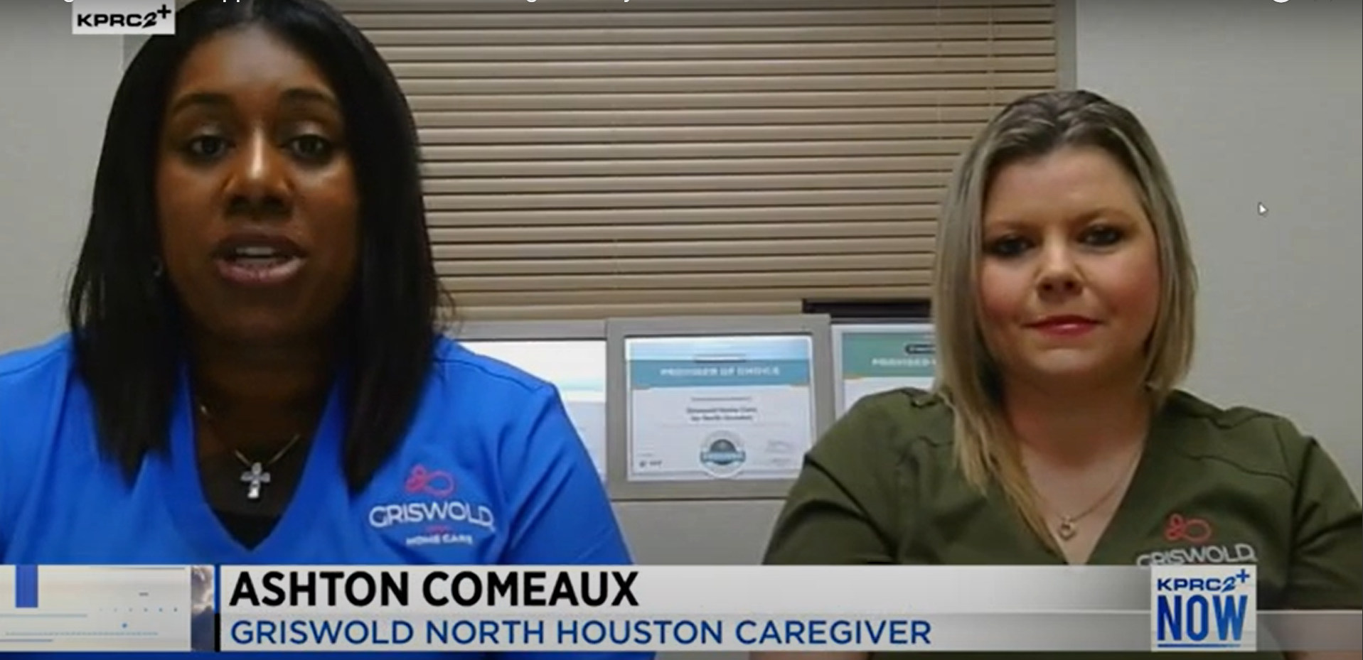 Two caregivers, one in a blue uniform and the other in a green uniform, are seated indoors. A title at the bottom identifies the individual on the left as Ashton Comeaux, Griswold North Houston Caregiver. They are dedicated professionals providing exceptional elder home care services.