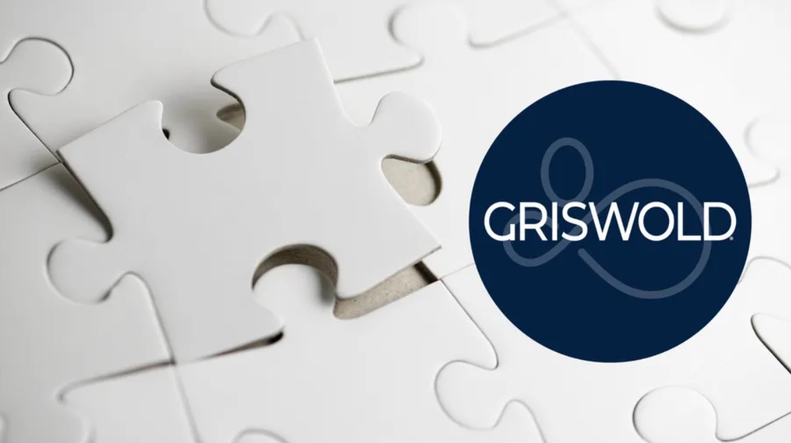 A white puzzle piece partly placed within a puzzle, beside a dark blue circle containing the word "GRISWOLD," symbolizes seamless care pairing through personalized caregiver services.